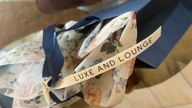 Interior view of Luxe and Lounge Boutique with curated clothing displays.